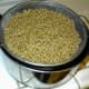 After wheat is well rinsed, put colander over cooking pan to let all the water drain away. While the water drains away, prepare the table.