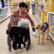 Assistance dog helps the lady shopping
