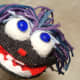 I made funny eyeballs using polished stones. I easily glued them to puff balls from an old Christmas Stocking, and then to the Puppets face! Just look at all of that personality!