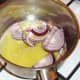 Red onion slices are added to melted butter