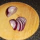 Red onion half is finely sliced for gravy