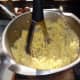 Mashing the potatoes with a good quality potato masher.