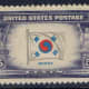 This U.S. stamp is an example of a printing error. The name under the flag should be "Korea", but has a plate flaw that makes it into "Korpa".