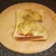 Melted cheese is seasoned with black pepper