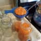 Step 20: Using your canning funnel, ladle sauce into each of your quart jars up to the bottom of the rim of each jar.
