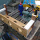 Gluing and screwing the smaller pieces of wood to the main cable management trough. The back pieces being slightly longer so that they can be screwed to the wall under the desk