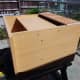 scrap wood used to make a back for the new lower shelf, designed with a gap at the top to make cable management behind the unit easier