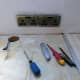 Turning off the power, unscrewing the wall sockets, and nipping up to 1/2 inch wallpaper behind the socket; for a neat finish