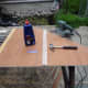 Using a strip of 4mm plywood to make a decorative cover for the piano hinge joining the two door segments