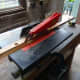 Trimming a piece of pine salvaged from a redundant shoe rack, and being recycled to fix a wood strip between the wardrobe and cupboard doors for the cupboard door bolts