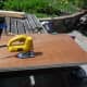 Using a jig saw to cut the curve in the sheets of plywood