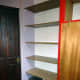 The old veneered chipboard shelving emptied, ready for dismantling and replacing