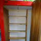 The new book case, made from pine floorboards (6 inches depth), in a more accessible location. On the back wall, the outline of the original pigeonhole shelves, that were previously removed because they were too deep