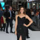Promoting Total Recall in long black strapless gown with a thigh high slit