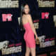 Megan Fox in a hot pink, form fitting, short dress and high heels