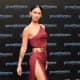 Megan Fox in a revealing dress with a hip high slit up the side wearing platform high heels