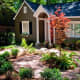 Great curb appeal. Focal point here is the lovely tree with its surrounding seating area.