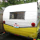 Glamour camper exterior after our DIY "$50 Paint Job" and polish. John Deere yellow mixed 1:1 with White. Wings & stripe polished with Mother's Polish.