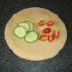 Tomato and cucumber form the garnish for the pasta along with some green salad leaves
