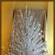 This is an early 1960s Peco 7-foot aluminum Christmas Tree with 151 pom-pom end branches. 