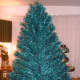 This is a vintage emerald green and blue 7-foot stainless aluminum Christmas tree. This is a must-have for a true vintage tree lover.