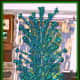 This blue and green Pom Pom Silver Forest tree is 92 inches tall from the bottom of the stand to the top of the tree with a small branch that sticks in the top. There are 114 branches.