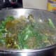 BRING PARTIALLY COOKED GREENS UP FROM THE BOTTOM WHILE ADDING MORE GREENS TO POT.