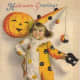 Free vintage Halloween card: little boy clown with pumpkin
