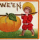 Free vintage Halloween card: two little boys carrying a large pumpkin