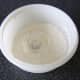Flour, yeast and salt are mixed together in a bowl. A well is made in the centre where the water and olive oil will be added