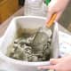 Thoroughly mix your cement mortar with just enough water to make a slurry the thickness of peanut butter.
Using your trowel scoop the slurry into your mold then smooth it out using the edge of the trowel until it is evenly spread.