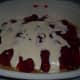 The first layer with strawberry pie filling and cream mixture.