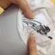 I print a template of the design showing the centers. Try to get it as close to the bottom as possible making sure the machine can stitch without interference from the seam and sweatband.