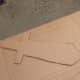 Cut out two cardboard pieces with the corrugation going in different directions to make piece stronger.