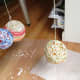 Hang yarn balls over wax paper or newspaper to dry for 24 hours.