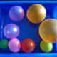 Blow up 8 water balloons in sizes to represent the planets.  Blow up a larger balloon for the Sun.