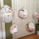 Hang paper mache planets to dry. Protect the floor with newspaper or an old bed sheet.