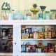 A shelf or cabinet with glass pane is the perfect place to display vintage containers, cans, tupperware and more!