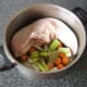 Vegetables and seasonings are added to the pot