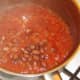 Borlotti beans are added to beef and tomato pasta sauce