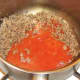 Spicy plum tomato pasta sauce is added to browned beef