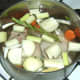Water is added to duck legs and stock ingredients