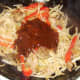 Hoisin and garlic sauce added to duck leg stir fry