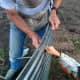 Note the tool apron which keeps the nuts handy, and the long punch which can be braced to align bolt holes.
