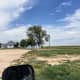 You can see where this grass next to the driveway has been driven on with trucks, tractors, and other equipment. This area is used for temporary equipment and grain bin hopper storage.