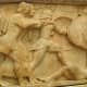 Siphnian Treasury, close-up of Apollo (short tunic) and his twin sister Artemis (longer gown) taking on the Giants.