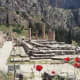 The foundations of the Temple of Apollo at Delphi, with ever-present poppies.
