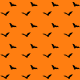 Free flying bats scrapbook paper on an orange background