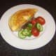 Poached chicken omelette is laid on toast