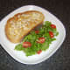 Chicken butter toast is plated with salad